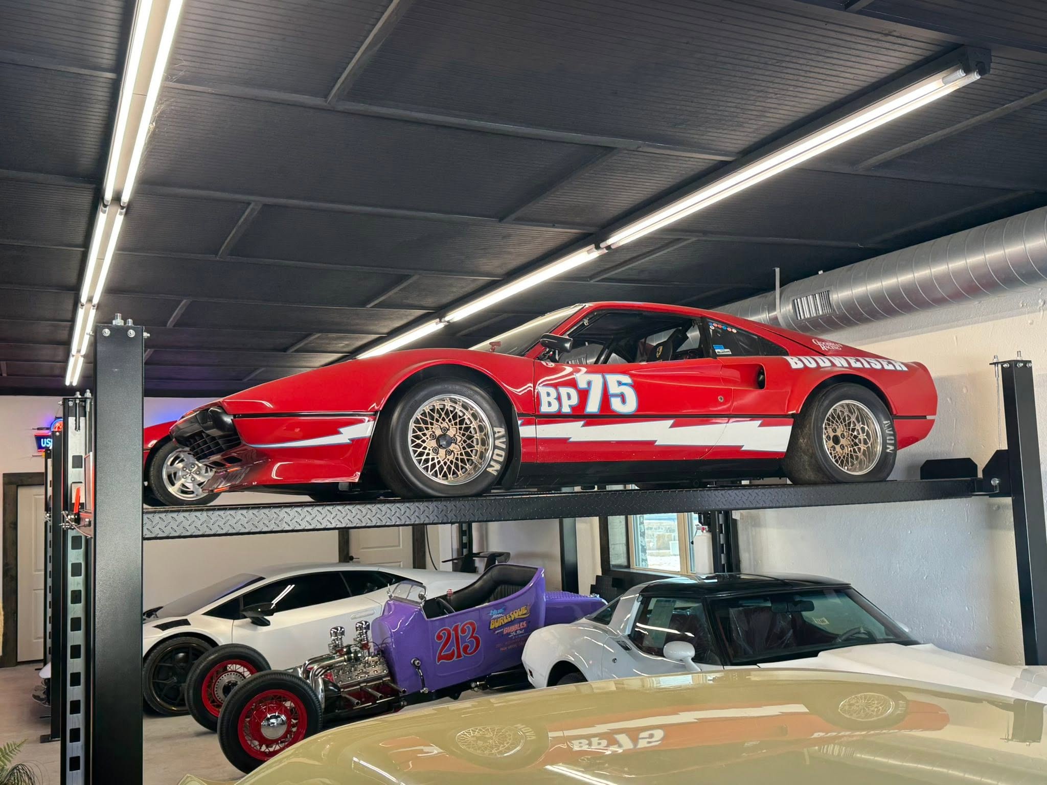 Red race car, hot rods, and custom vehicles stacked in the GMTV collection