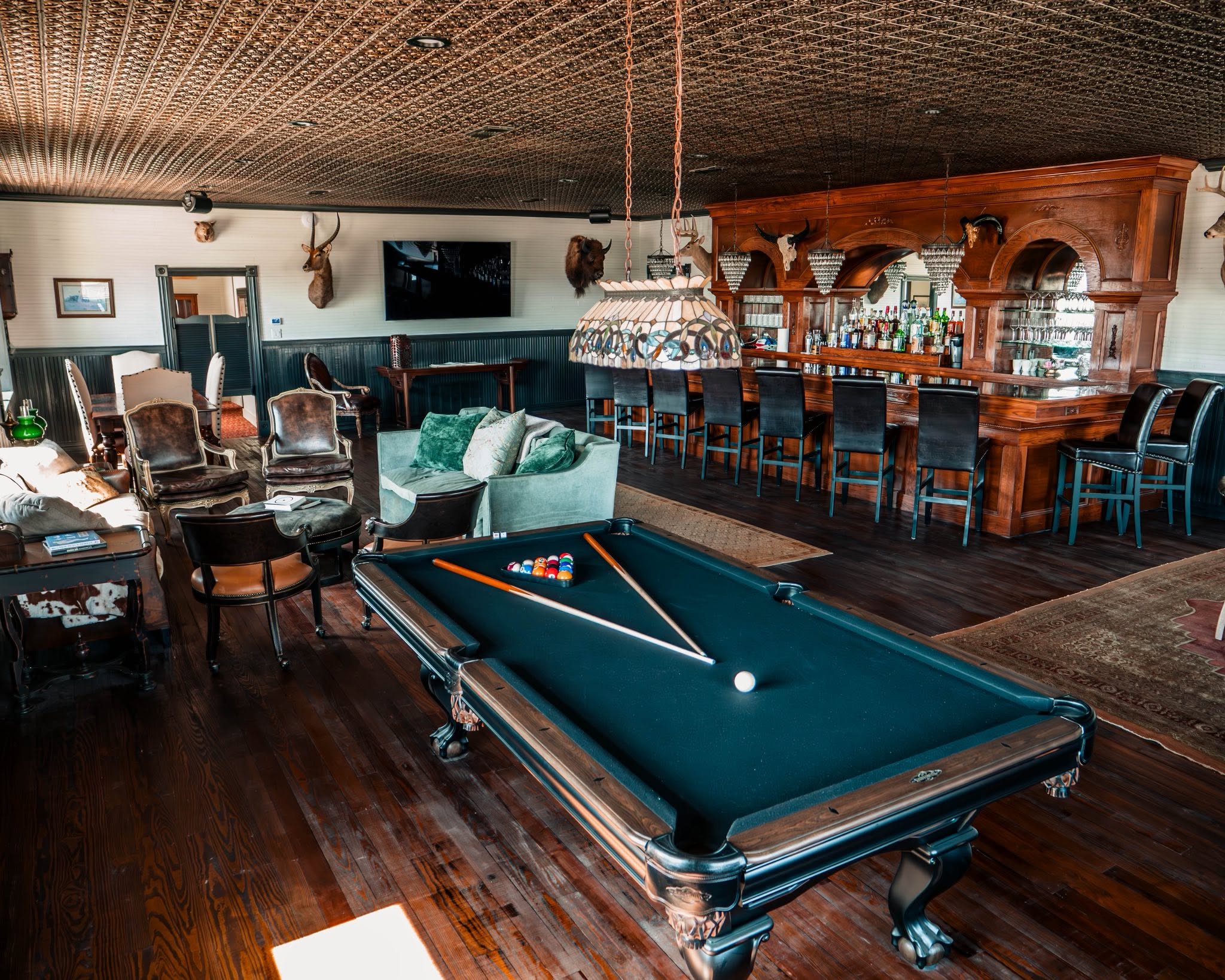 Pool table and carved wood saloon bar inside GMTV Garage