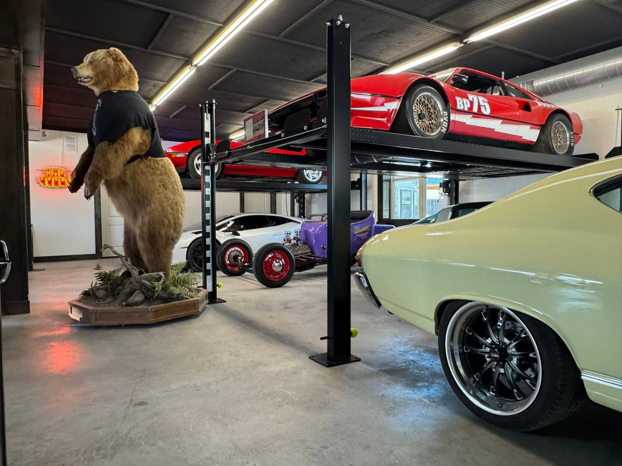 Collector cars and bear display in the industrial GMTV Garage