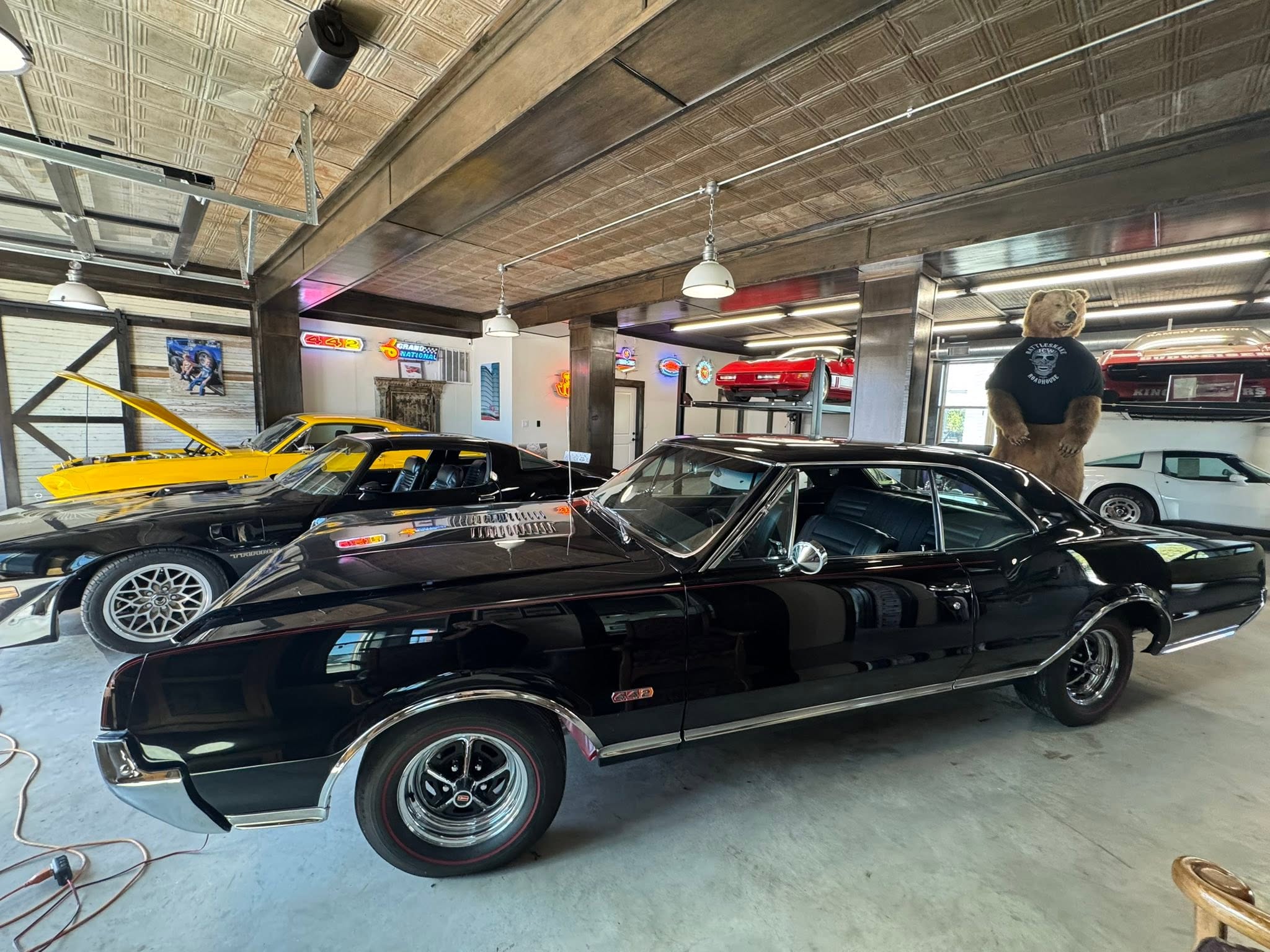 Three classic collector cars lined up inside GMTV Garage