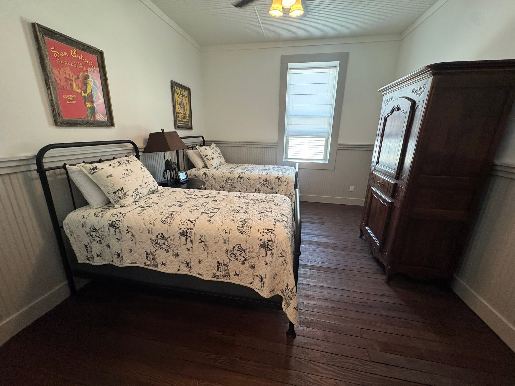 Cream bedroom with dark wood floors at GMTV Garage